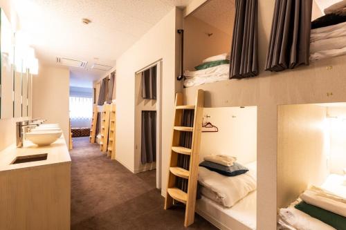 a dorm room with bunk beds and a bathroom at Sekine Building 4th floor - Vacation STAY 75338v in Tokyo