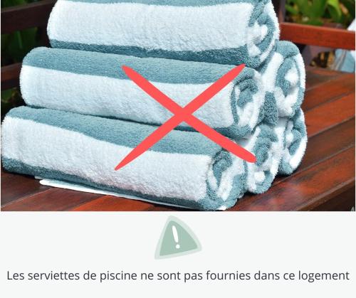 a stack of towels with a red x at Le Mazet du Mont Ventoux in Malaucène