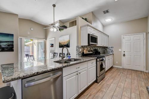 a kitchen with white cabinets and a counter top at Beautiful Las Vegas Home in Las Vegas