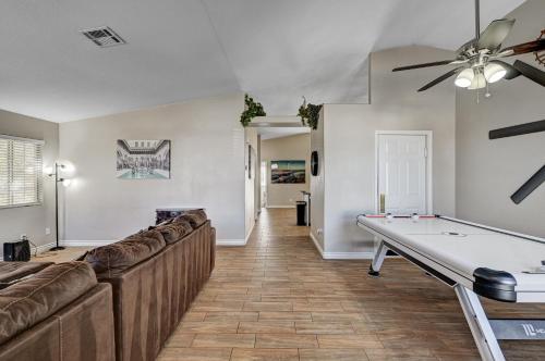 a living room with a couch and a ping pong table at Beautiful Las Vegas Home in Las Vegas
