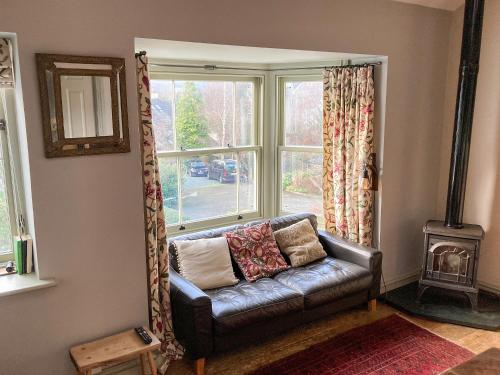 a living room with a couch in front of a window at 11 The Plosh in Keswick