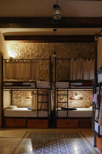 a room with two bunk beds in a room at Hotel & Hostal Boutique Casa Garza in Mérida