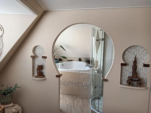 a bathroom with a glass shower and a sink at Modern Cozy Asian Style bedroom with Kingsize Spa bath in Westbeemster