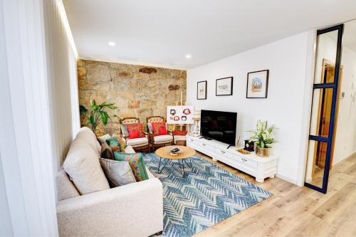 a living room with a couch and a fireplace at Lendalima Formosa in Ponte de Lima