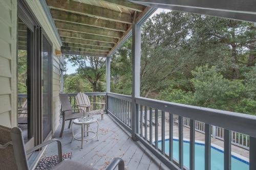 a screened in porch with a table and chairs on it at 4603 - Yellow Brick Road in Southern Shores