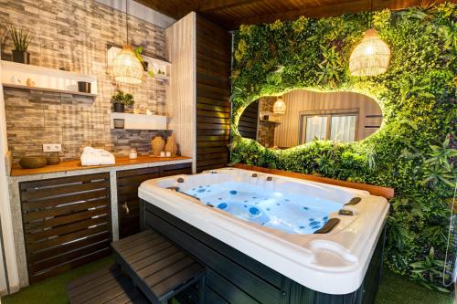 a bath tub in a bathroom with a mirror at Lendalima Formosa in Ponte de Lima