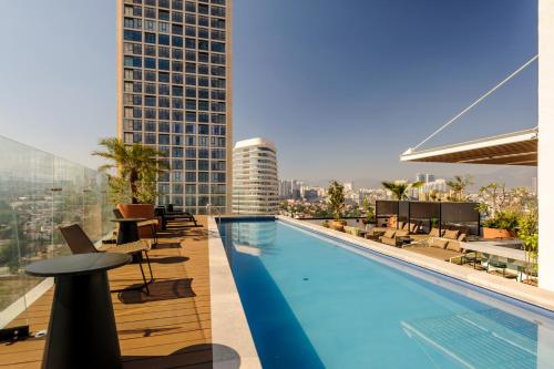 a swimming pool on the roof of a building at Amazing Apartments in the Heart of Interlomas in Mexico City