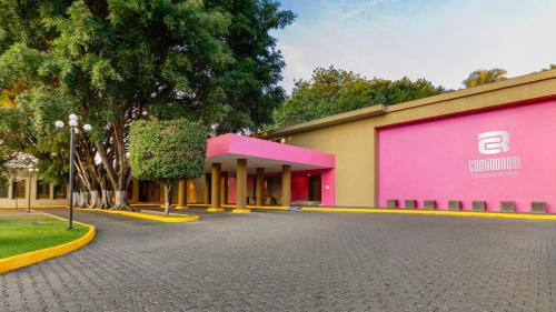 a building with a pink and yellow building at Camino Real Guadalajara in Guadalajara