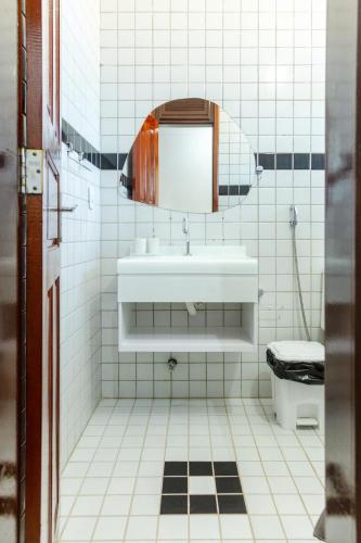 a white bathroom with a sink and a toilet at Beachfront Studio with Pool Caponga in Cascavel