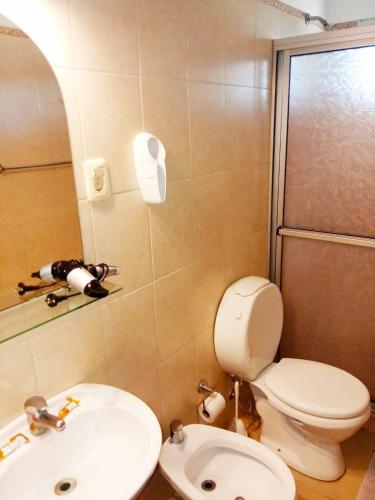 a bathroom with a toilet and a sink at Natural Agave in Termas del Daymán