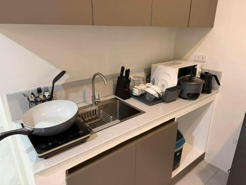 a kitchen counter with a sink and a bowl at Stay Inn Apartelle in Roxas City
