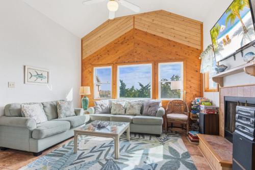 a living room with a couch and a fireplace at 8194 - Southern Grace in Waves