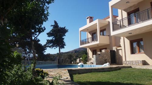 a view of a house with a swimming pool at Petrochori ApartHotel in Petrochori