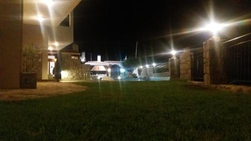 a yard lit up at night with street lights at Petrochori ApartHotel in Petrochori