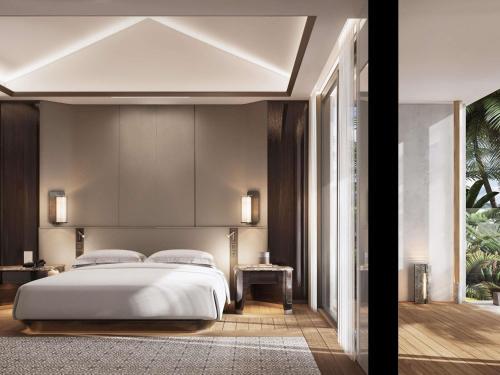 a bedroom with a large white bed in it at Navera Phuket - MGallery Collection in Surin Beach