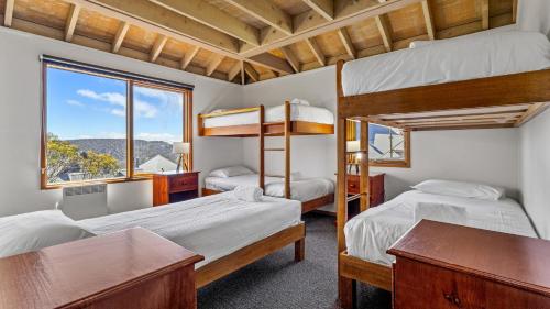 a bedroom with two bunk beds and a window at Eagles Nest in Mount Hotham