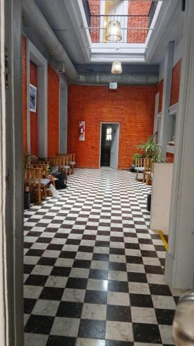 a room with a black and white checkered floor at Hostel Las Lengas in Buenos Aires