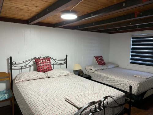 a bedroom with two beds in a room at DREAM LAND Lake Front CHALET, HOT TUB in Huntingdon