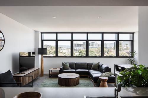 a living room with a couch and a table at Astra Apartments Wollongong Beatson Street in Wollongong