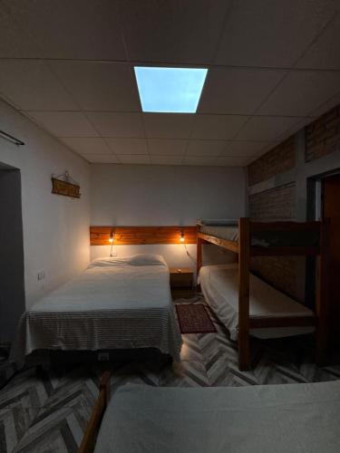 a bedroom with two bunk beds and a skylight at En Armonía in Tinogasta
