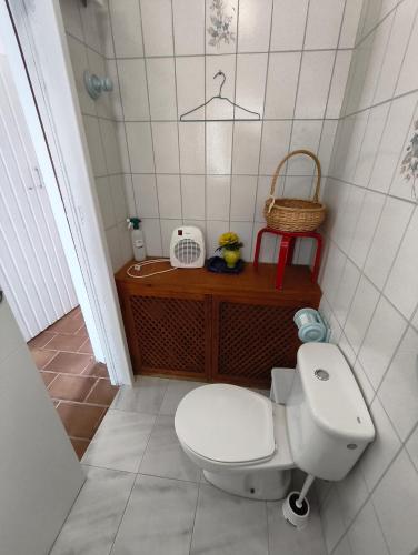 a bathroom with a toilet and a basket on a table at Vistaluz playa in Matalascañas