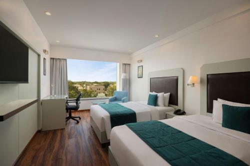 a hotel room with two beds and a window at The Fern Residency Jodhpur, Series by Marriott in Jodhpur