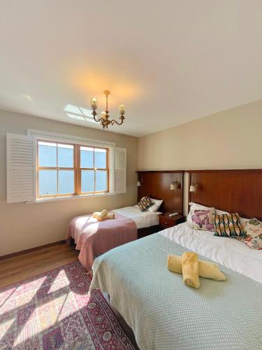 a hotel room with two beds and a window at Nore River House in Kilkenny