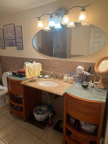 a bathroom with a sink and a mirror at DREAM LAND Lake Front CHALET, HOT TUB in Huntingdon