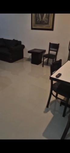 a living room with chairs and a table and a couch at Suites Destination in Cuatrociénegas de Carranza