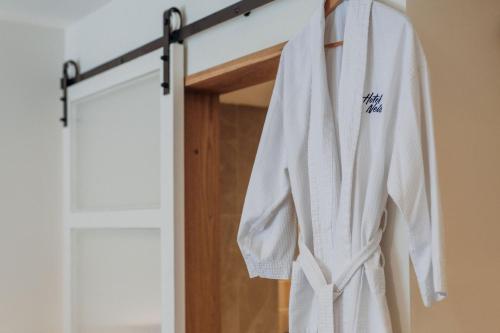 a robe hanging in front of a door at Hotel Nelson in Nelson Bay