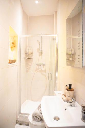 a bathroom with a shower and a sink and a toilet at City-Centre Gem Modern Top-Floor Retreat in Cambridge