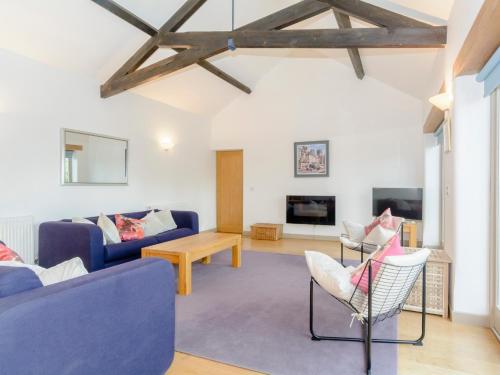 a living room with a blue couch and chairs at Marigold in Shepton Mallet