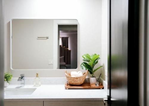 a bathroom with a sink and a mirror at Modern 1BR w/ Workspace near O'Hare in Chicago