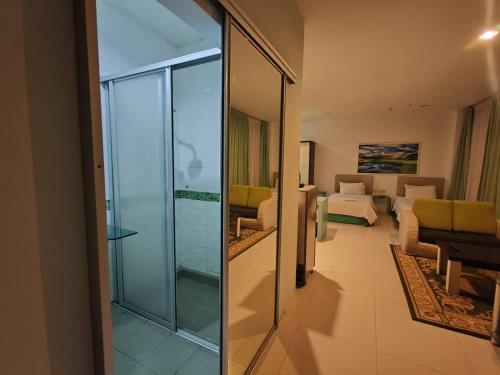 a living room with a glass door to a living room at Santorini Hotel in Miri