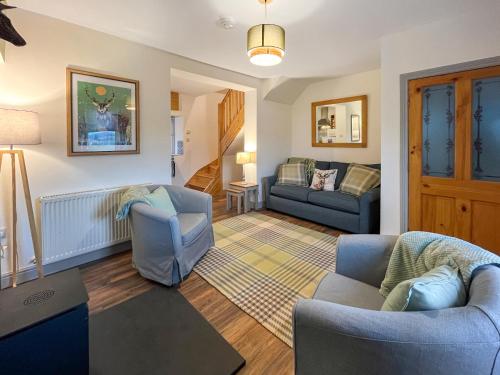 a living room with two chairs and a couch at Rubylea in Dumfries