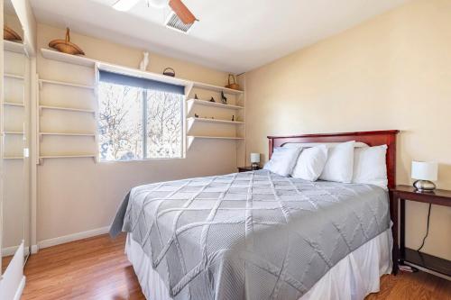 a bedroom with a bed and a window at Old Town Cottonwood Cottage in Cottonwood