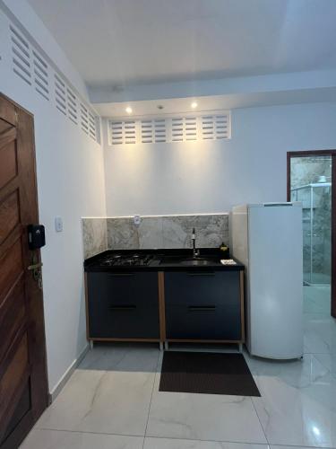 a kitchen with a sink and a refrigerator at Studio - Serraruna in Araruna