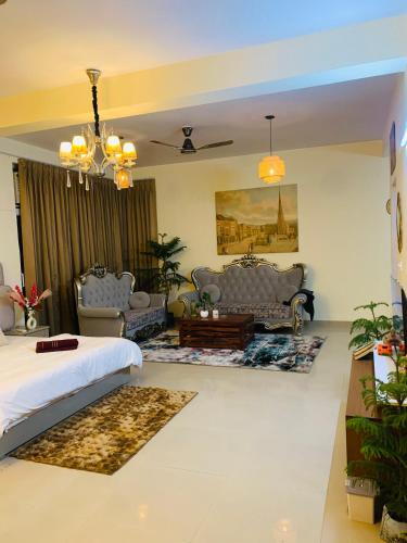 a bedroom with a bed and a living room with furniture at Celebirity garden 4 bhk -5 Bed Lulu and plassio mall gomti nagar in Lucknow