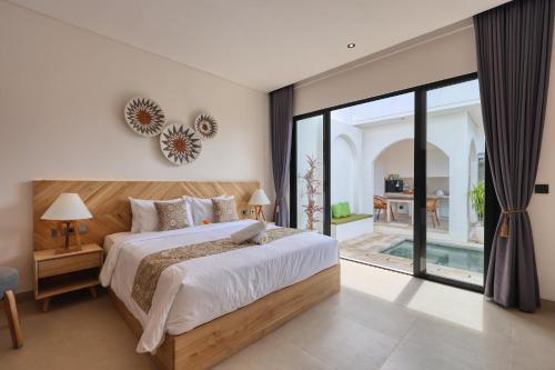 a bedroom with a large bed and a large window at Asaka Private Villa in Nusa Penida