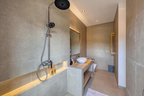 a bathroom with a shower and a sink at Asaka Private Villa in Nusa Penida