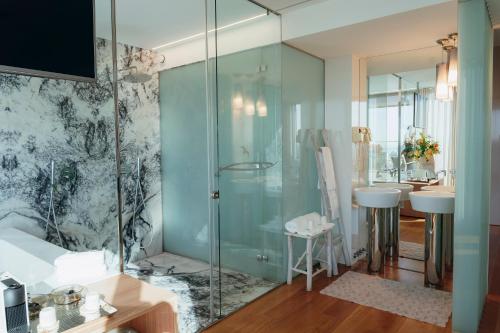 a bathroom with a glass shower and a sink at Hotel Costa Verde in Póvoa de Varzim