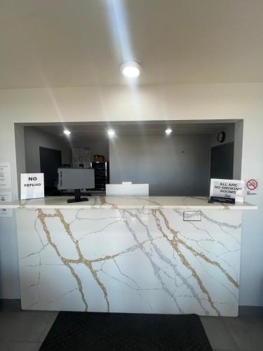 a room with a marble counter with signs on it at Westowne Inn Paducah I-24 Exit 4 in Paducah