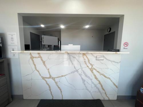 a room with a marble counter with a mirror at Westowne Inn Paducah I-24 Exit 4 in Paducah
