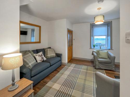 a living room with a couch and a chair at Rubylea in Dumfries