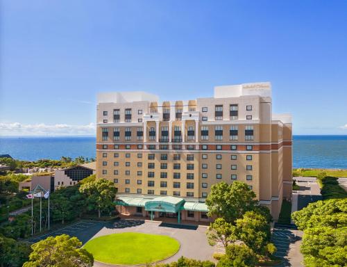an aerial view of a hotel with the ocean in the background at Hotel Okura Tokyo Bay in Urayasu