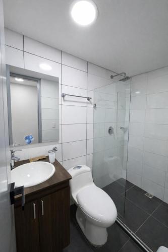 a bathroom with a toilet and a sink and a shower at Hotel Ivanna - Laureles in Medellín