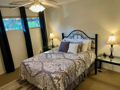 a bedroom with a bed and a ceiling fan at Riverfront with EV charger - Sequoia River Cottage in Three Rivers