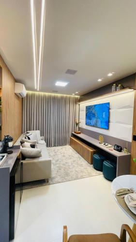 a large living room with a large screen tv at Studio home office Inteligente Com Alexa no Coração do Shopping in Mogi das Cruzes