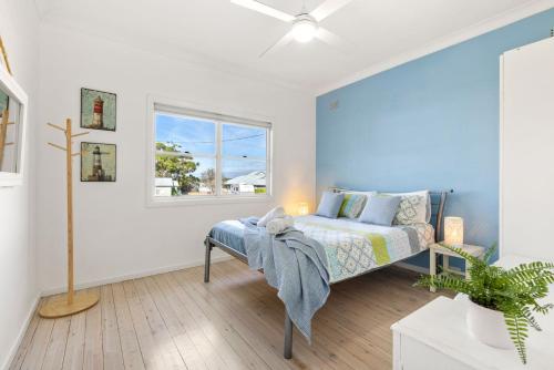 a bedroom with a bed and a window at Beauts - Pet Friendly - 5 Mins Walk to Beach in Culburra Beach