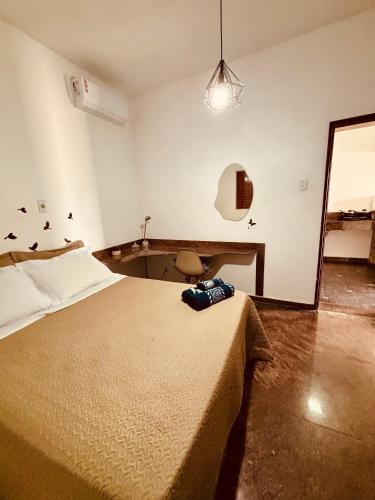 a bedroom with a large bed and a mirror at Pousada e Flat Royal 04 in Itapecerica
